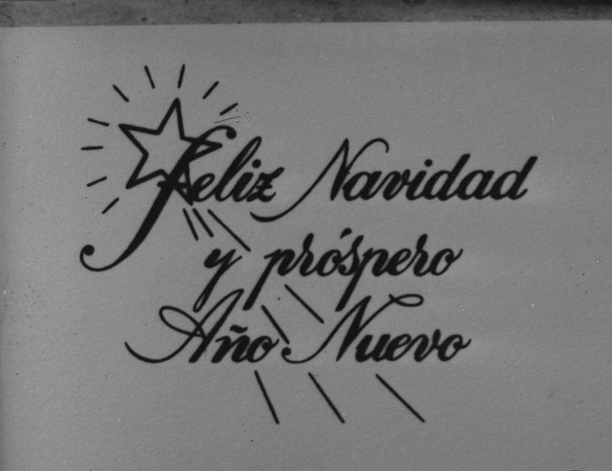 Reproducción de fotografía. Primer plano de postal -Feliz Navidad y próspero año nuevo-