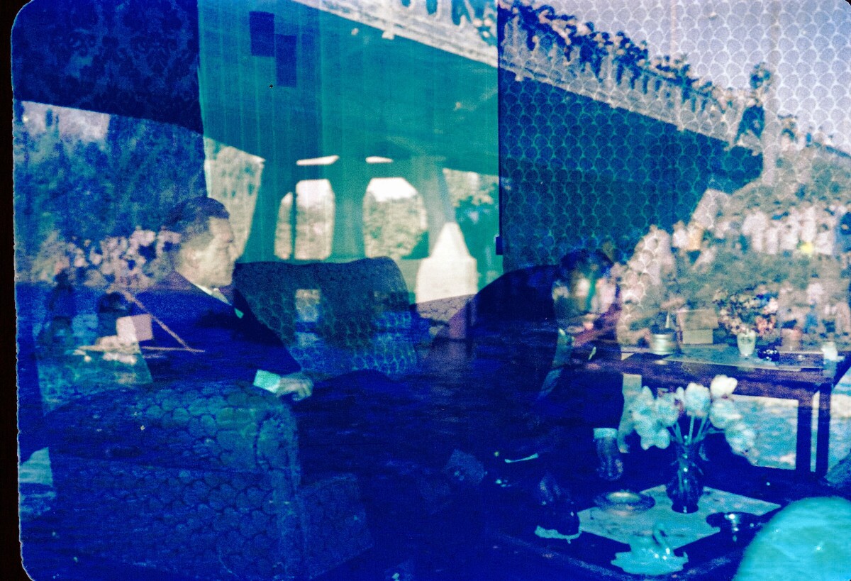 Fotografía de doble exposición. 1- Plano entero de dos hombres sentados en un living. 2- Plano entero personas viendo hacia el río desde el borde de un puente.