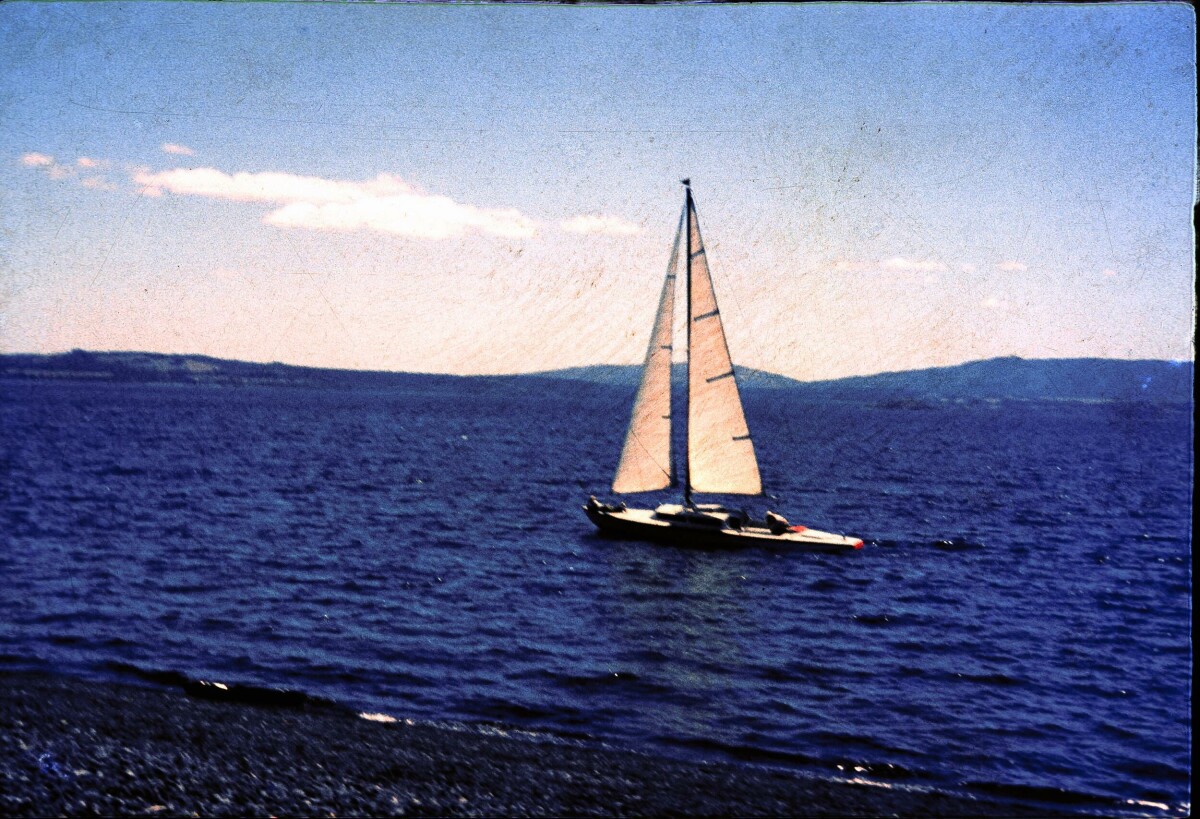 Plano entero de un velero a orillas de un lago